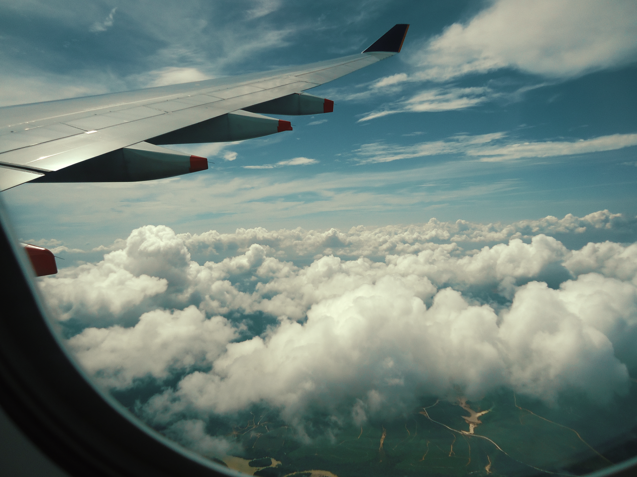Serene view of fluffy white clouds from an airplane window during a scenic flight.