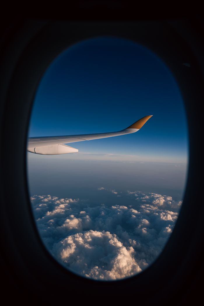 services-03 Wing view from airplane with stunning cloudscape at high altitude during flight.